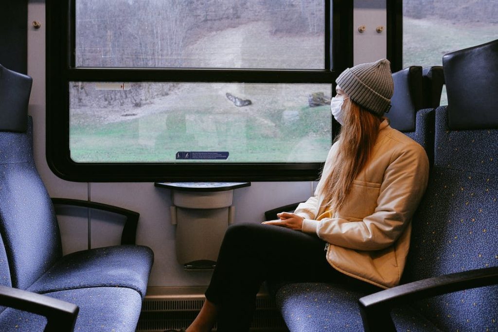 Woman wearing mask on train