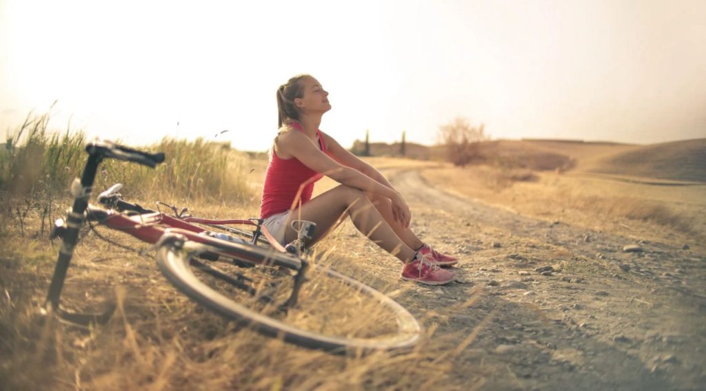 Woman resting from bike ride.