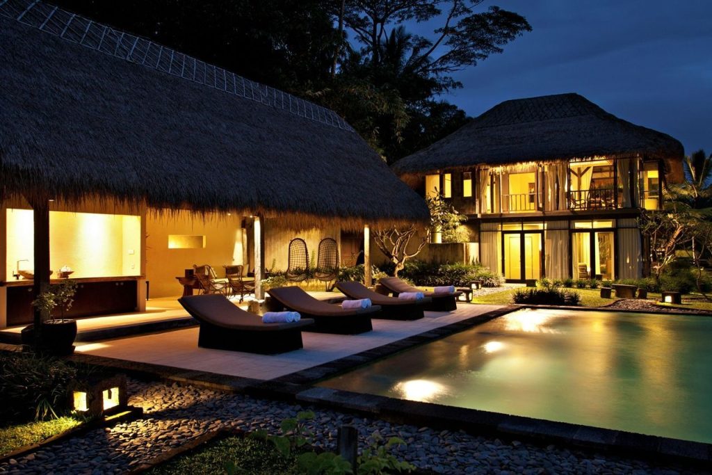 Villa at dusk with lights on