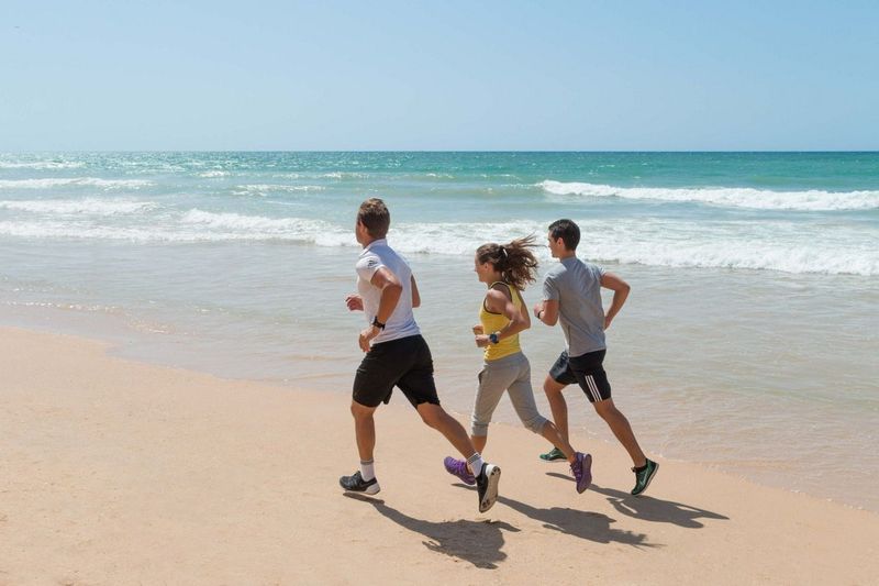 Group of people running on the beach
