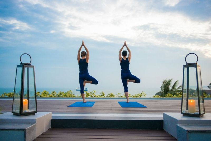two people practicing yoga on a retreat