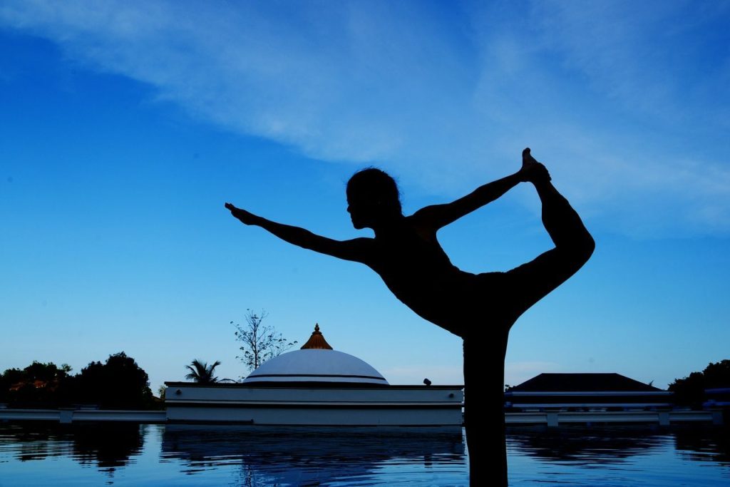 Woman doing a yoga pose by the pool at Absolute Sanctuary in Thailand