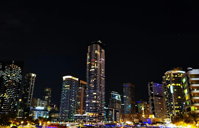 Stunning night view of the Dubai Marina skyline with illuminated skyscrapers reflecting urban vibrancy.